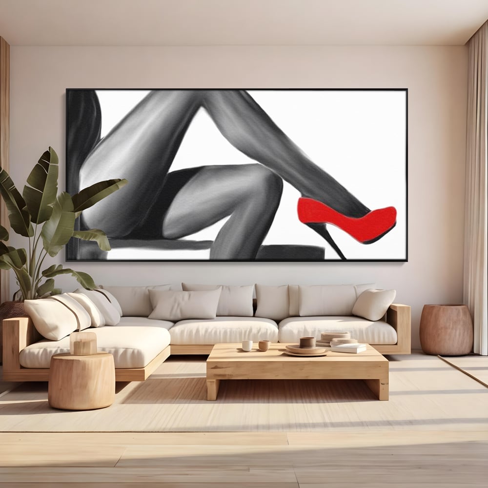 Tablou canvas cu illustratie alb negru cu picioare si pantof rosu, in rama de aluminiu negru, pe perete intr-un living
